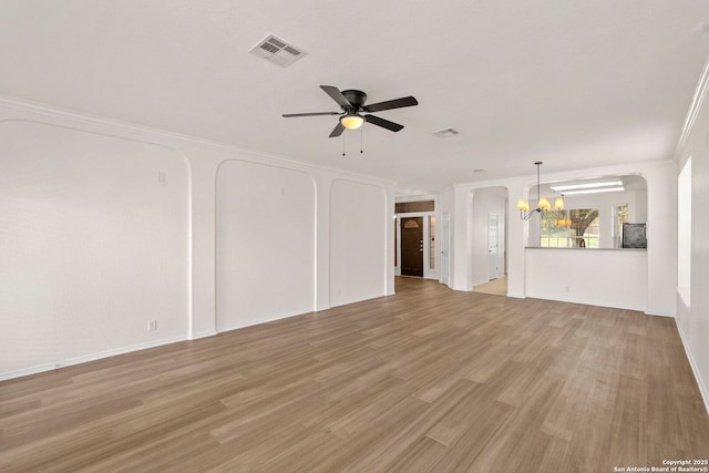 665 La Bahia Loop, New Braunfels, TX 78132 - unfurnished living room with arched walkways, a chandelier, ceiling fan, ornamental molding, and light wood finished floors