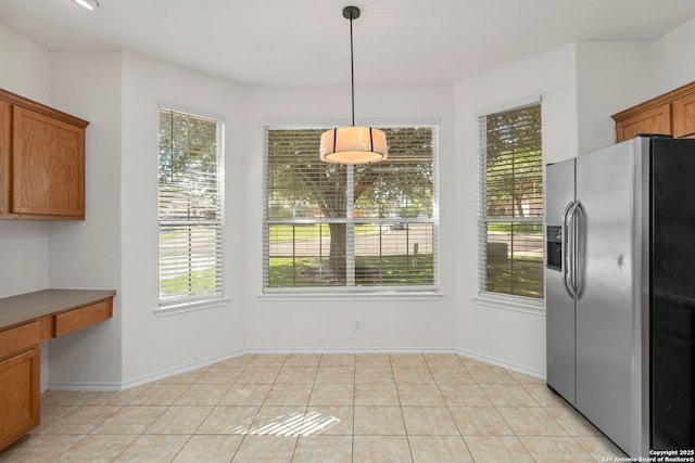 665 La Bahia Loop, New Braunfels, TX 78132 - unfurnished dining area featuring built in study area and light tile patterned floors