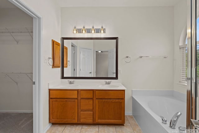 665 La Bahia Loop, New Braunfels, TX 78132 - full bath with a bath, double vanity, a walk in closet, and tile patterned floors