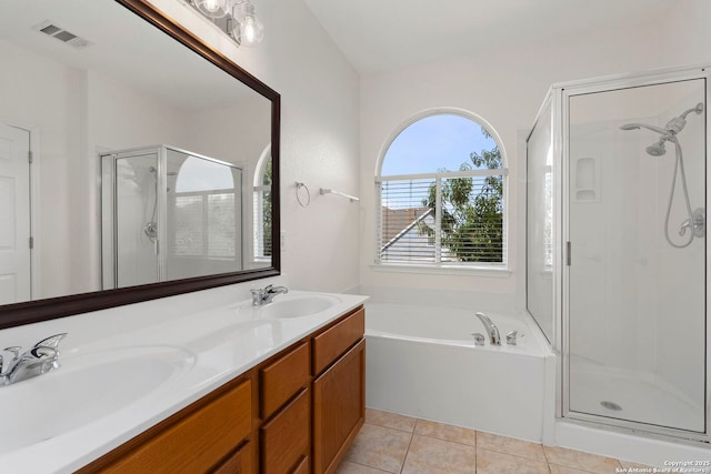 665 La Bahia Loop, New Braunfels, TX 78132 - bathroom with a stall shower, a garden tub, double vanity, and tile patterned floors