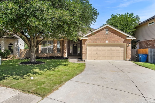 665 La Bahia Loop, New Braunfels, TX 78132 - view of front facade featuring driveway, a garage, and brick siding