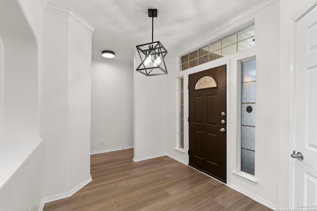 665 La Bahia Loop, New Braunfels, TX 78132 - foyer with wood finished floors, a chandelier, ornamental molding, and arched walkways