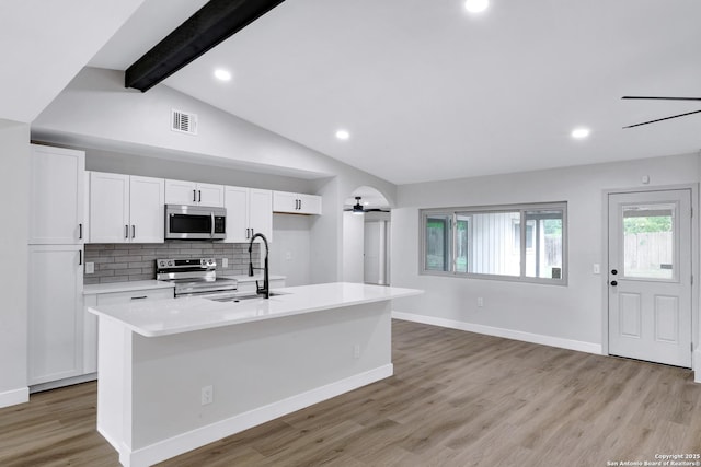 5807 Sun Rdg, San Antonio, TX 78247 - kitchen with appliances with stainless steel finishes, a ceiling fan, white cabinets, light countertops, and light wood-style flooring