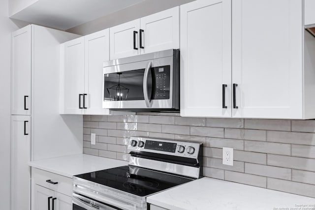 5807 Sun Rdg, San Antonio, TX 78247 - kitchen with stainless steel appliances, white cabinets, decorative backsplash, and light stone counters