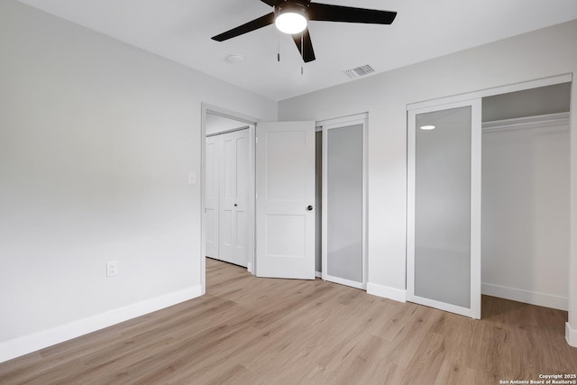 5807 Sun Rdg, San Antonio, TX 78247 - unfurnished bedroom with multiple closets, light wood finished floors, and ceiling fan