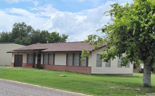403 E Meyer, Falls City, TX 78113 - ranch-style house with a front lawn, brick siding, and a shingled roof