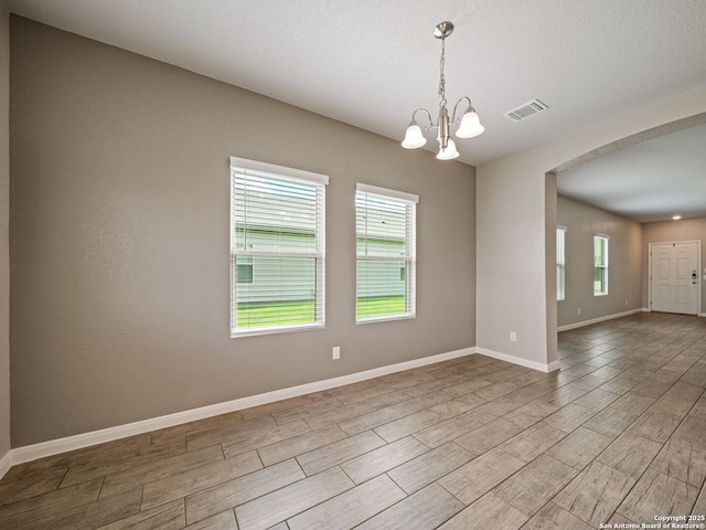 754 Farmers Dell, New Braunfels, TX 78130 - empty room featuring wood tiled floors, a chandelier, and arched walkways
