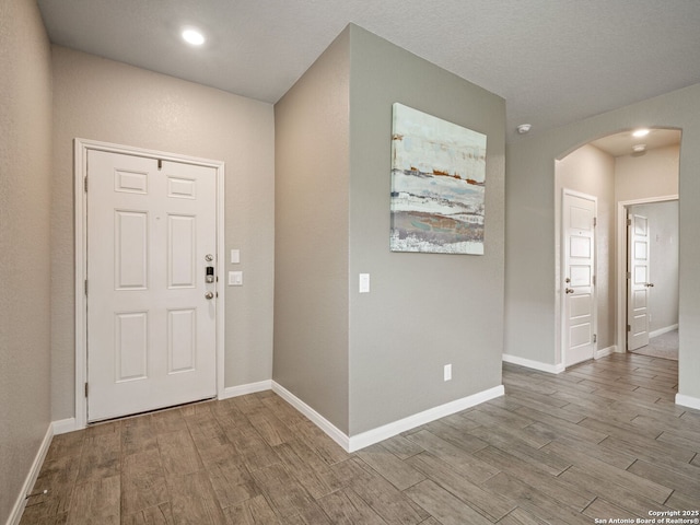 754 Farmers Dell, New Braunfels, TX 78130 - entryway featuring arched walkways, wood finished floors, and recessed lighting
