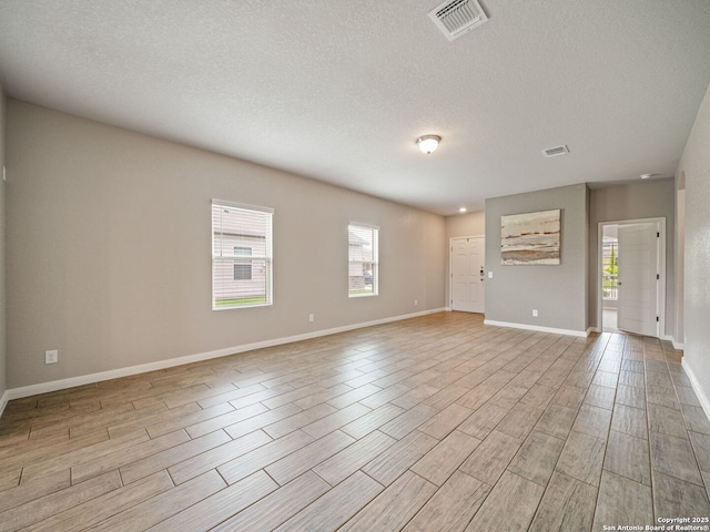 754 Farmers Dell, New Braunfels, TX 78130 - spare room featuring light wood finished floors and a textured ceiling