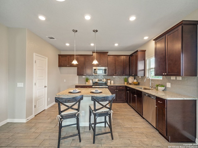 754 Farmers Dell, New Braunfels, TX 78130 - kitchen featuring stainless steel appliances, decorative backsplash, wood tiled floors, dark brown cabinetry, and recessed lighting