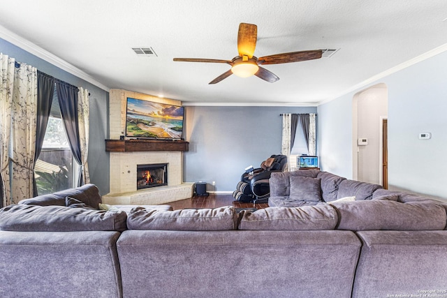5938 Smoky Quartz, San Antonio, TX 78222 - living area featuring arched walkways, a ceiling fan, ornamental molding, wood finished floors, and a brick fireplace