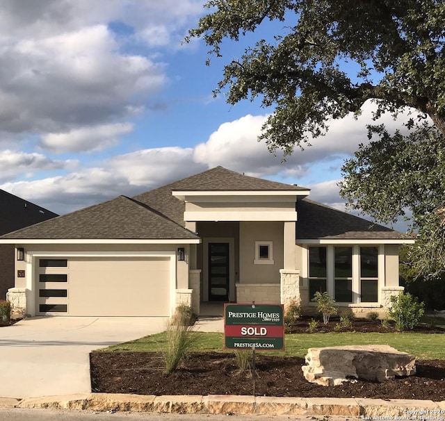 prairie-style home featuring a garage