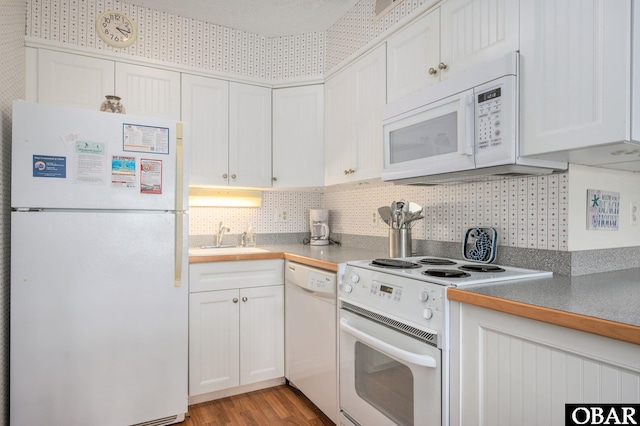 117 Sea Colony Dr Unit 211B, Duck, NC 27949 - kitchen with light wood-style floors, a sink, white cabinets, and white appliances