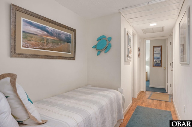117 Sea Colony Dr Unit 211B, Duck, NC 27949 - bedroom featuring baseboards, attic access, and wood finished floors