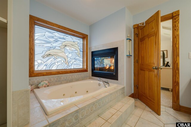 bathroom featuring tile patterned flooring and a whirlpool tub