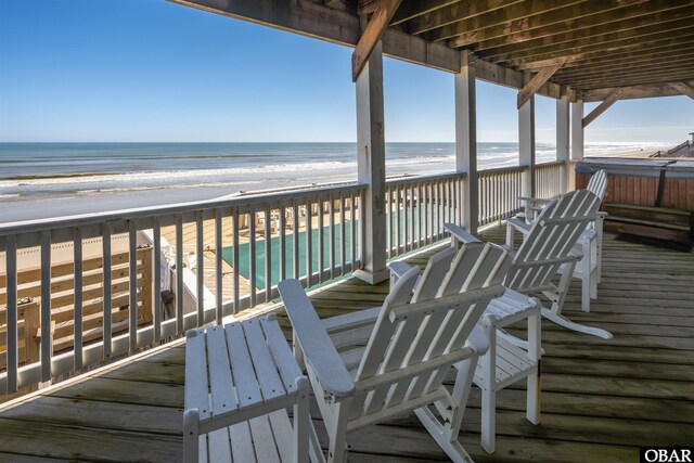 wooden terrace with a beach view and a water view