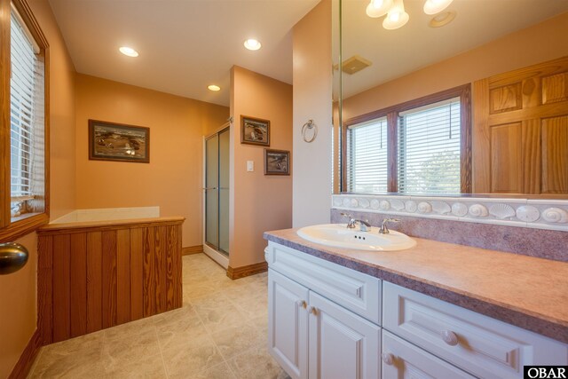 bathroom with vanity, visible vents, baseboards, recessed lighting, and a shower stall