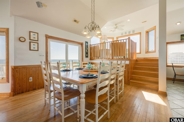 dining space featuring an inviting chandelier, light wood-style flooring, visible vents, and wainscoting