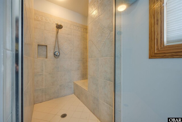 full bath with a tile shower