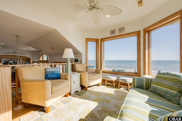 living area with visible vents, a water view, a ceiling fan, wood finished floors, and recessed lighting