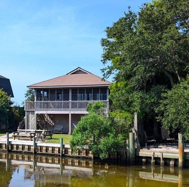 52 Fish Camp Lane Lot# 94& P95, Ocracoke, NC 27960 - rear view of house with a sunroom, a water view, roof with shingles, and stairs