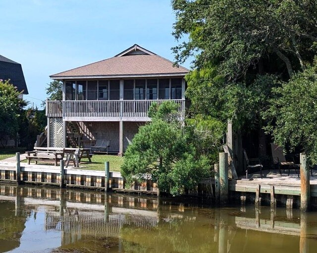52 Fish Camp Lane Lot# 94& P95, Ocracoke, NC 27960 - rear view of house with a sunroom, roof with shingles, stairway, and a deck with water view