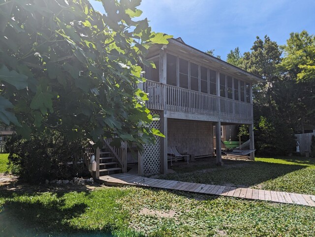 52 Fish Camp Lane Lot# 94& P95, Ocracoke, NC 27960 - back of property with a sunroom, stairway, and a yard