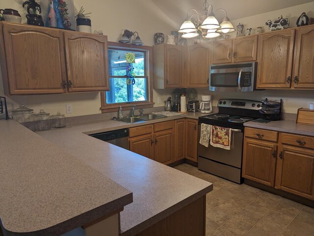 52 Fish Camp Lane Lot# 94& P95, Ocracoke, NC 27960 - kitchen featuring appliances with stainless steel finishes, a sink, a peninsula, a chandelier, and hanging light fixtures