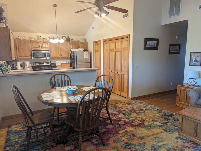 52 Fish Camp Lane Lot# 94& P95, Ocracoke, NC 27960 - dining area with ceiling fan, high vaulted ceiling, light wood-type flooring, a chandelier, and baseboards