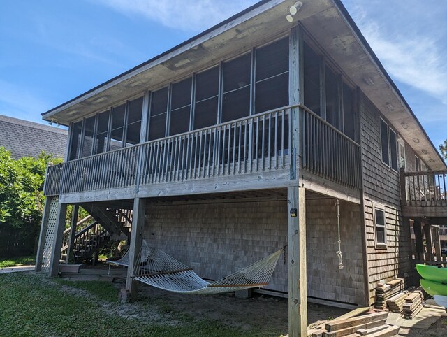 52 Fish Camp Lane Lot# 94& P95, Ocracoke, NC 27960 - rear view of property featuring a sunroom, stairway, and a deck