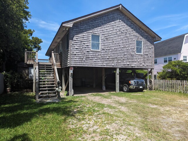 52 Fish Camp Lane Lot# 94& P95, Ocracoke, NC 27960 - rear view of house with a carport, stairs, and driveway