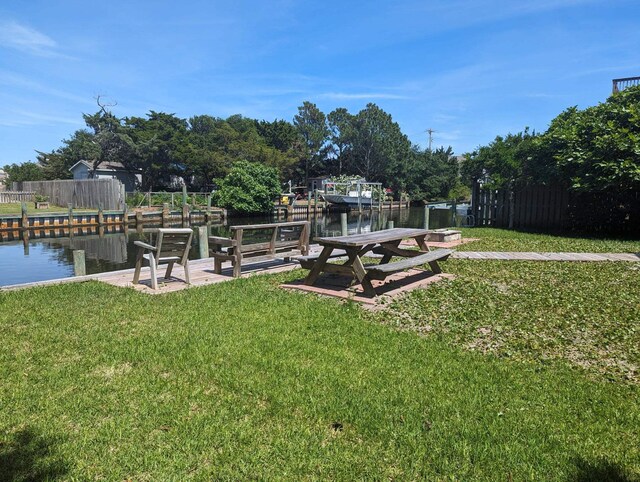 52 Fish Camp Lane Lot# 94& P95, Ocracoke, NC 27960 - view of green lawn featuring a water view and a dock
