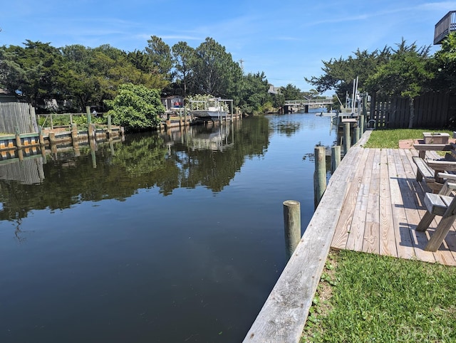 dock area with a water view and boat lift