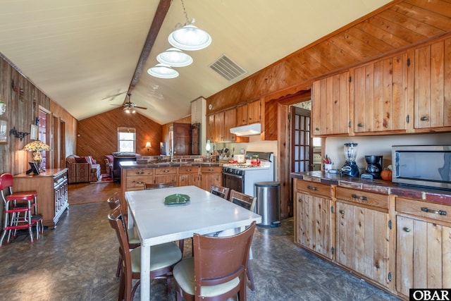 278 Bayview Dr, Stumpy Point, NC 27978 - kitchen with white range with gas stovetop, wooden walls, under cabinet range hood, lofted ceiling, and a peninsula