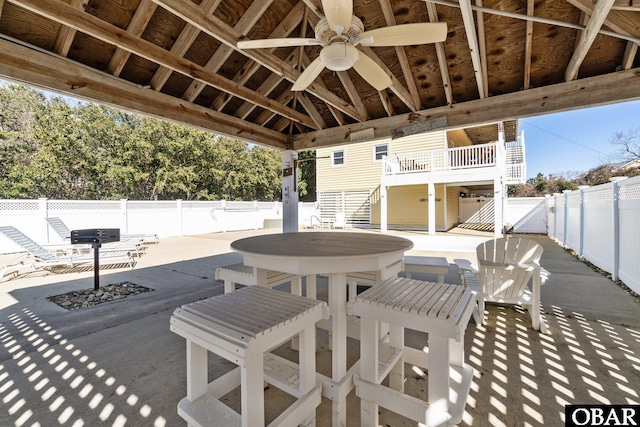 view of patio with outdoor dining area, a fenced backyard, and stairway