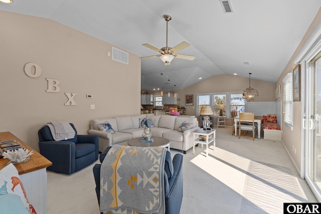 living area featuring visible vents, vaulted ceiling, and light colored carpet