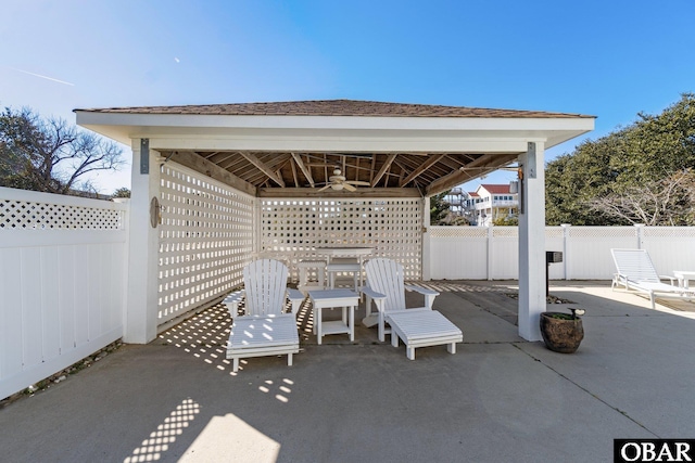 view of patio / terrace featuring a fenced backyard, ceiling fan, and a gazebo