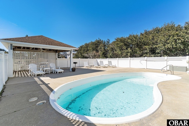 view of pool with a patio area, a fenced backyard, a fenced in pool, and a gazebo