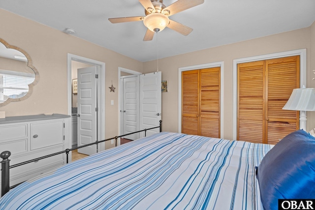 bedroom featuring multiple closets and ceiling fan