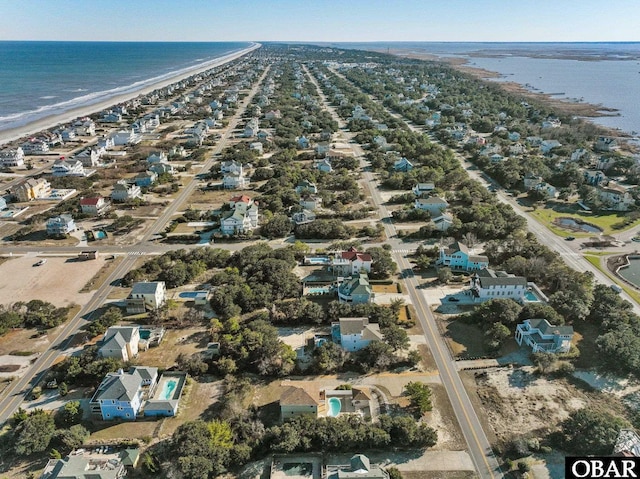 bird's eye view with a water view and a beach view