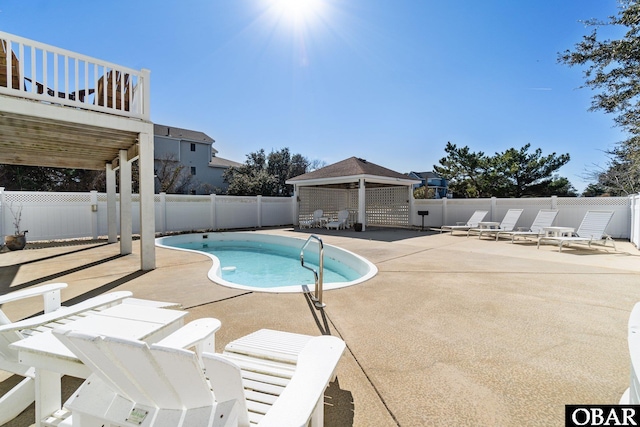 view of swimming pool featuring a patio, a gazebo, a fenced backyard, and a fenced in pool