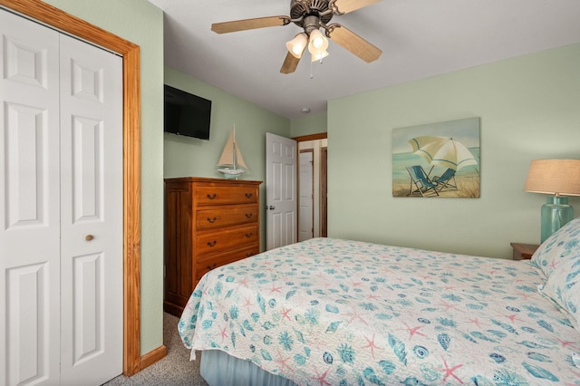 carpeted bedroom featuring ceiling fan and a closet