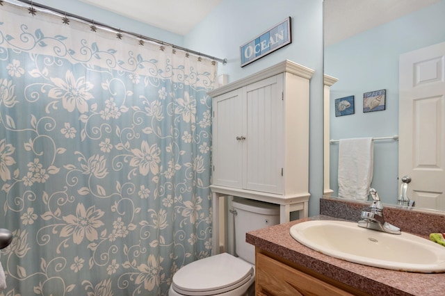 bathroom featuring vanity and toilet