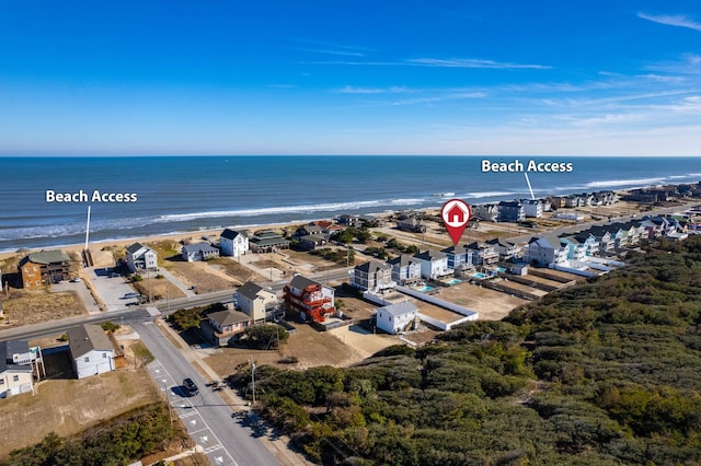 birds eye view of property featuring a water view and a view of the beach