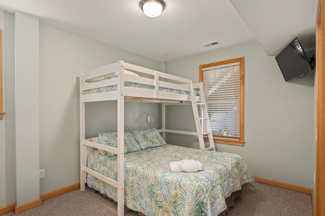 carpeted bedroom with visible vents and baseboards