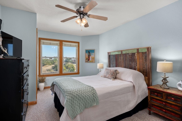 bedroom with light carpet, ceiling fan, and baseboards