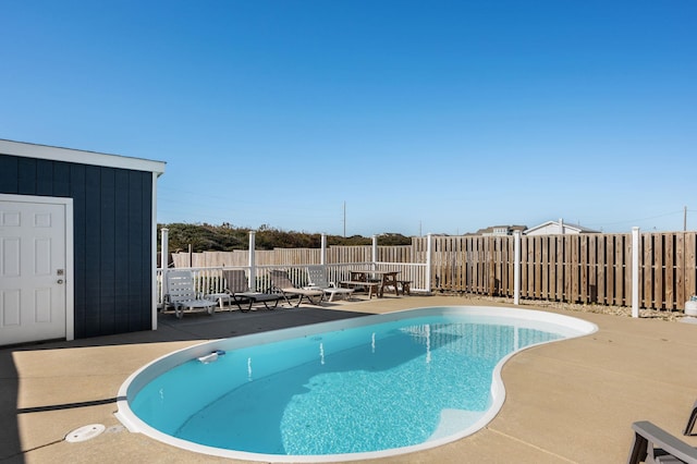 view of pool featuring a patio area, fence, and a fenced in pool