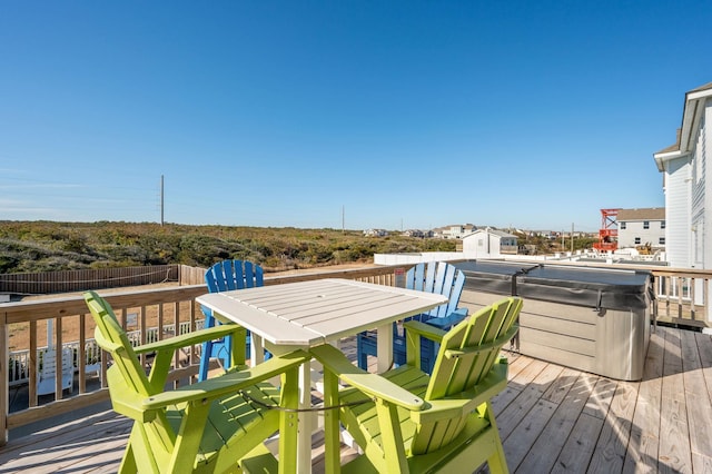 wooden deck featuring a hot tub