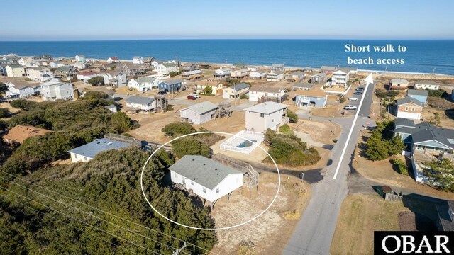 birds eye view of property featuring a water view and a residential view