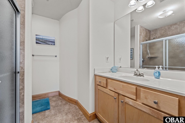 107 W Gray Eagle St Unit 103A, Nags Head, NC 27959 - full bathroom with a shower stall, vanity, and tile patterned flooring